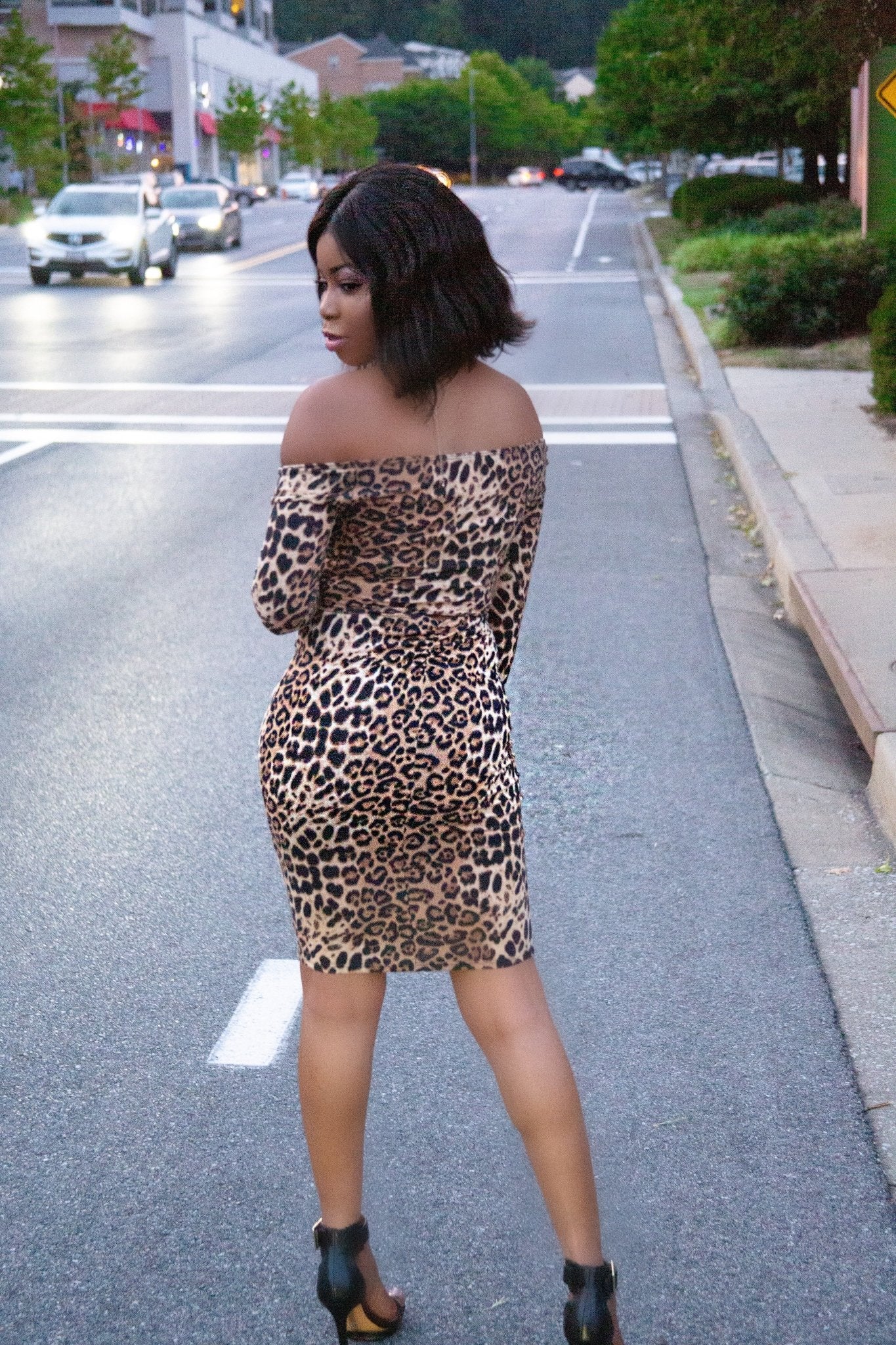 a woman walking down the street with a cell phone 